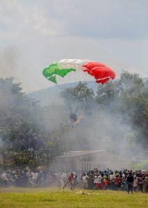 A person with a parachute landing in a crowd.